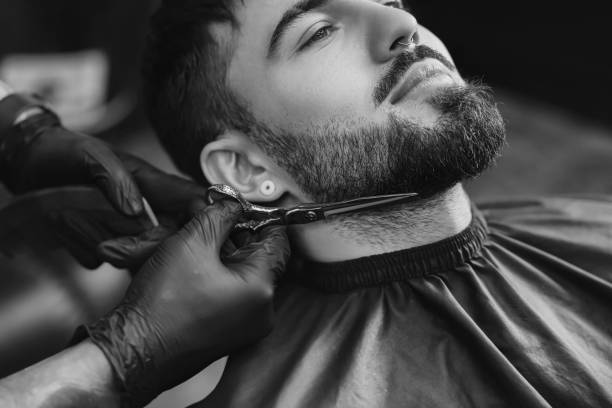 Barber shaping a beard line