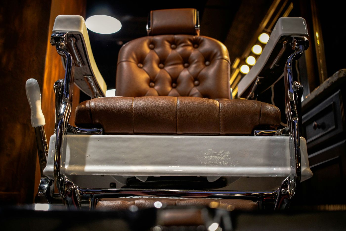 The barber chair, leather and chrome, waiting for the next appointment
