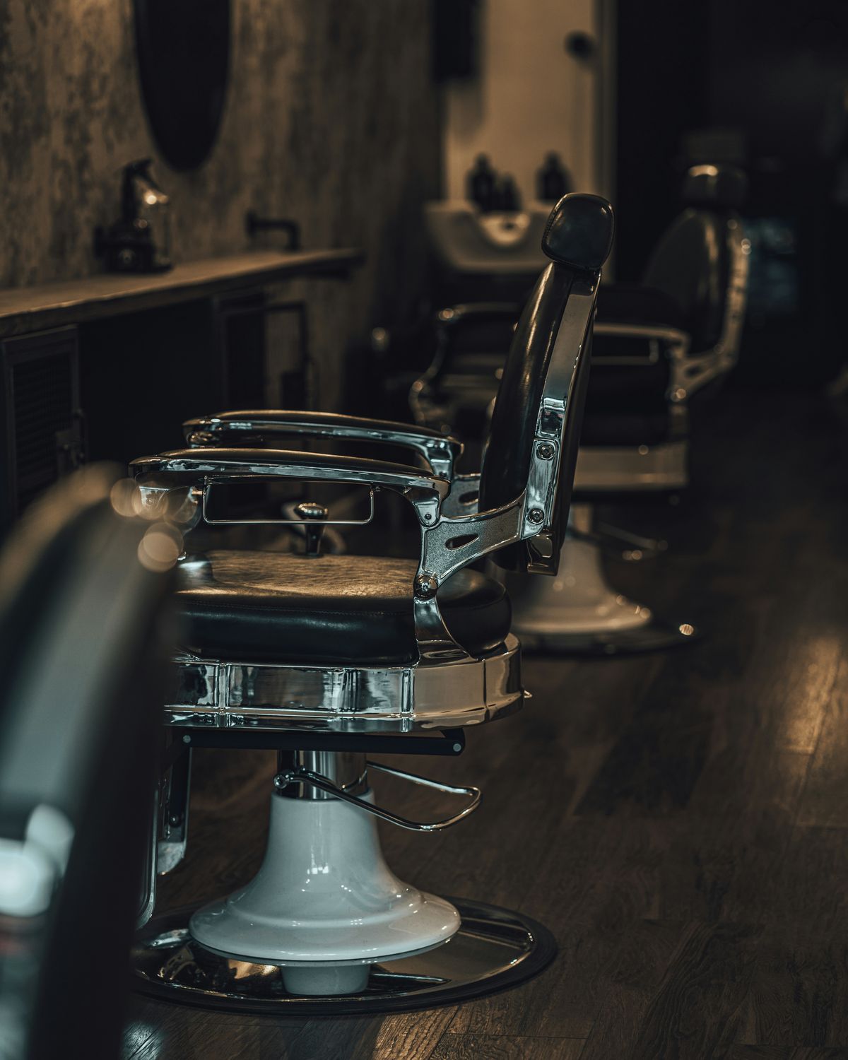 A row of barber chairs down the length of the shop