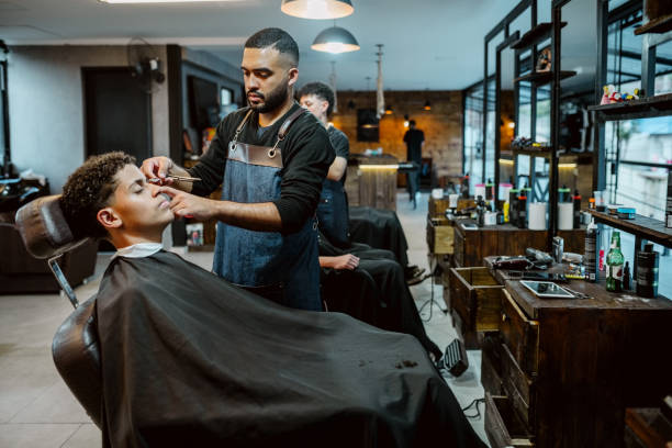 A careful finishing touch in the barber chair